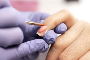 Manicure. Strengthening of natural nails with artificial material-gel. Nail care in a beauty salon. Close-up