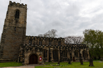 Fototapeta premium All Saints Church of England church built in 1517 and graveyard in Darton, South Yorkshire