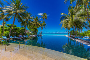 Tropical swimming pool. Luxury infinity pool under palm trees with sea horizon view. Summer travel vacation landscape, luxurious hotel resort. Stunning island landscape, paradise beach, exotic nature