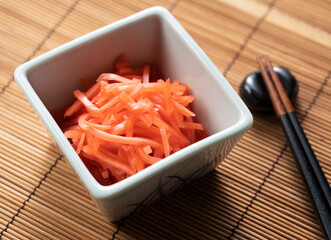Red pickled ginger placed on a Japanese background.
