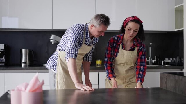 Couple take out macaroons from the oven