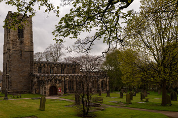 All Saints Church of England church built in 1517 and graveyard in Darton, South Yorkshire
