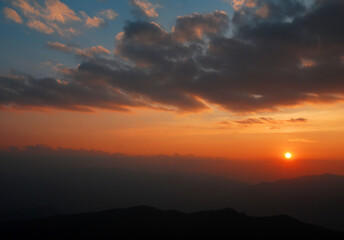 Tranquil scene of the sunset with Orange sky with cloud in the evening at doi pha hom pok national park Thailand. Twilight color