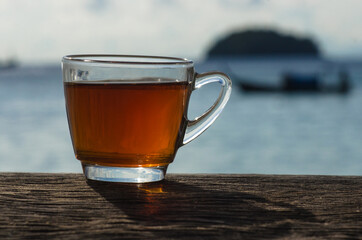 Cup of tea on the wooden table. seaside lipe. Thailand
