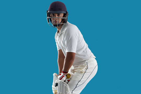  batsman ready to face the ball, isolated over Blue background	