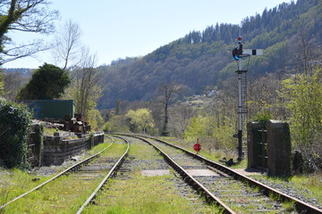Fototapeta premium a pair of railway lines heading towards Llangollen station with signals on the side of the track