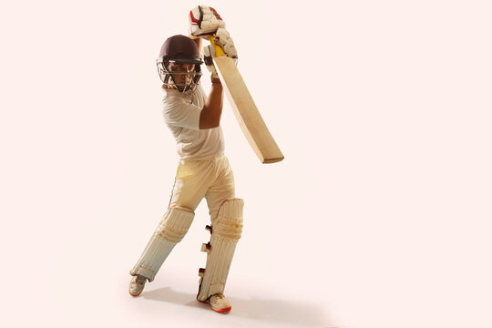 Cricketer, batsman practicing a shot in full gear 	