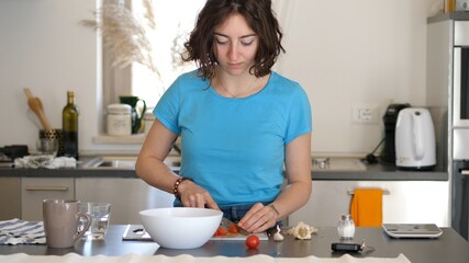 Young Pretty Italian Woman Cutting Fresh Tomatoes