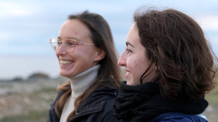 Young Lesbian Women Enjoying the Sunset at Sea