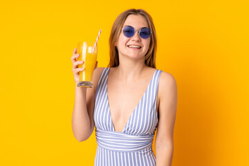 Teenager Ukrainian girl in swimsuit and holding a cocktail