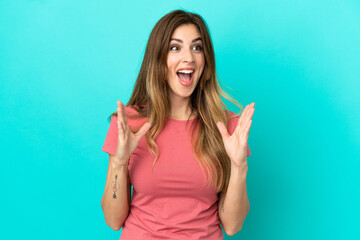 Young caucasian woman isolated on blue background with surprise facial expression