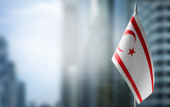 A small flag of Northern Cyprus on the background of a blurred background