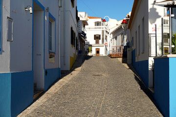typical narrow street in the fishing village of Salema on the Algarve south coast