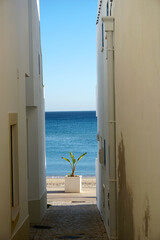 typical narrow street in the fishing village of Salema on the Algarve south coast