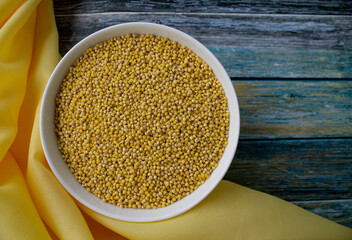 background. turquoise background. grits in a white bowl