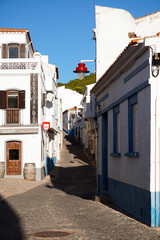 typical narrow street in the fishing village of Salema on the Algarve south coast