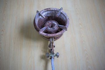 Aged portable high-pressure propane burner on a table