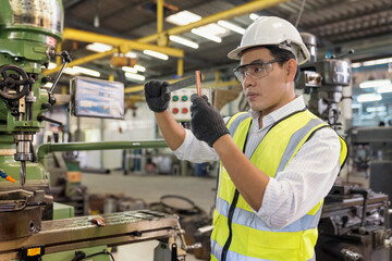 Engineers are working and repairing machines in industrial. Technician holding Measuring pliers....
