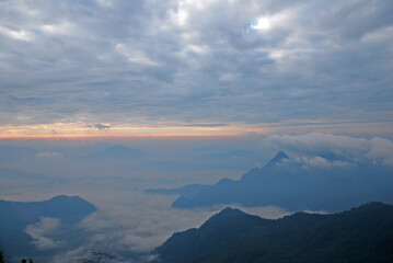 Landscape Nature scene landscape of Fog and Misty in the valley with light of sunrise in the morning of winter season at Phu Chi Fa , Chiangrai , Thailand