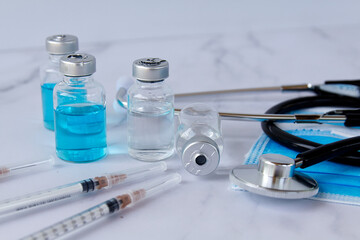 Fototapeta premium Vials and syringe on light background. Vaccination and immunization.