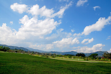 Nature scene of Green Grass Parks with Cloud blue sky background at singha parks , chiang rai , thailand