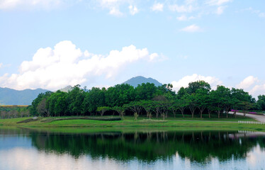 Naklejka na ściany i meble Tranquil scene Landscape of lake with mountain background and reflection of mountain and cloud sky in the lake at singha park chiang rai thailand 