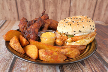  junk foods on plate on wooden table close up 