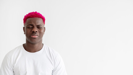 Sad black man. Disappointment regret. Dissatisfied feelings. Trouble difficulties. Depression problem. Upset african guy with bright pink hair almost crying isolated white copy space.
