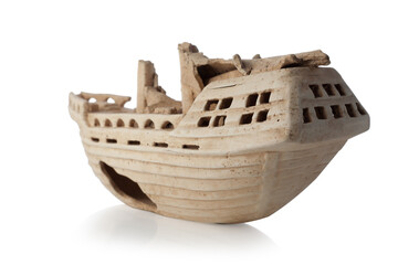 Sunken old ship isolated on white background. Decorative clay ship for the aquarium.