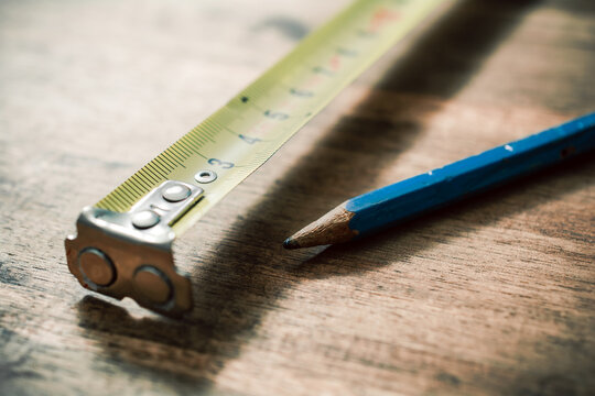 Pencil And Measuring Tape On An Vintage Wooden Table