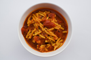 Gujarati popular side dish Sev tameta or Shev tamatar Curry homemade prepared from tomato and gramflour vermicelli. Indian cuisine food tomato vegetable gravy topped with crispy snack