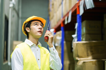 Warehouse worker wear safety equipment inspect and check goods package shelf in storage for supply...