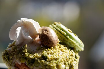 Close up view on traditional Easter cake decorated by macaroon and pistachio 