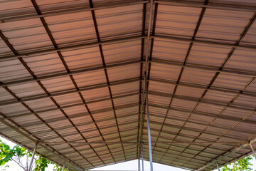 Steel roof structure. Moonlight bulb. Steel structure with roof tiles. Architectural structure of roof. Large roof layout used for industrial plants.
