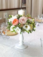 table decoration with flowers and candles. Flower Bouquet with Candles. Vertical photography