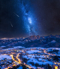 Milky way over illuminated Zakopane city in winter © shaiith