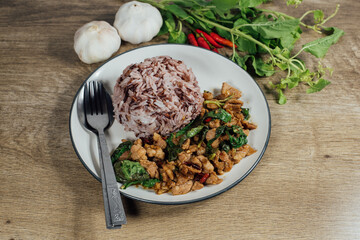 rice topped with Stir-fried pork and basil, Fresh Thai basil garlic chilli .