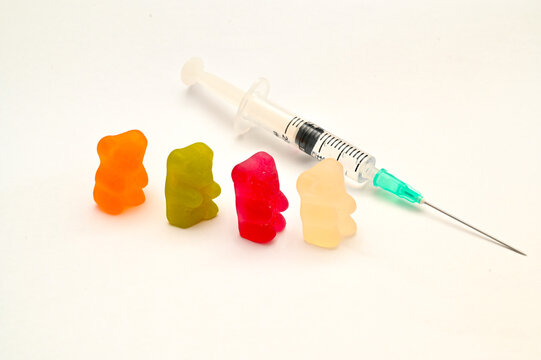 Jelly bears are waiting in queue for Covid 19 vaccine. Concept photo.