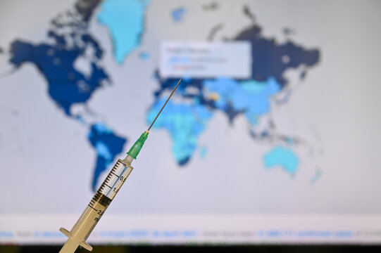 Syringe with world map background. Covid 19 vaccine is popular trend of world agenda