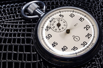 Stopwatch close-up. Chronograph round isolated on background. Macro. Clock. Scale of the measuring...
