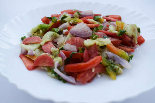 Indian authentic salad known as Kachumbar salad prepared from freshly chopped onions, tomato, cucumber, coriander and green chilly. Sprikled with lemon juice, salt, sugar, pepper powder.
