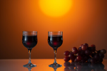 Two glasses of red wine on a beautiful sunset background. holiday mood