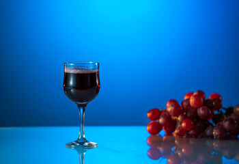Glass of wine on a beautiful blue background. holiday mood