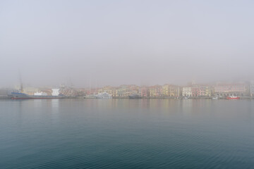 Fototapeta na wymiar Morning fog over Imperia coastal city, Italian Riviera