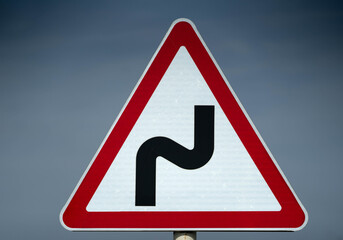 Road sign serpentine. dangerous turn. close up shot
