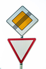 Road sign end of main road. road sign give way