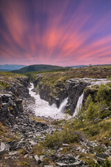 Fototapeta na wymiar beautiful waterfalls with crystal clear water with mountains in the background at sunset Norway.