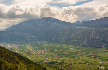 Fototapeta premium Rotaliana Valley landscape from Corona Mount in Trentino Alto Adige, northern Italy, Europe. Corona Mount is a 1,035 meter high mountain in the Val di Cembra.