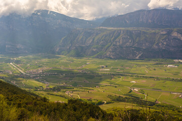 Fototapeta premium Rotaliana Valley landscape from Corona Mount in Trentino Alto Adige, northern Italy, Europe. Corona Mount is a 1,035 meter high mountain in the Val di Cembra.