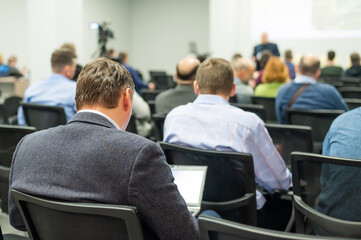 a man leading a discussion in a conference room.